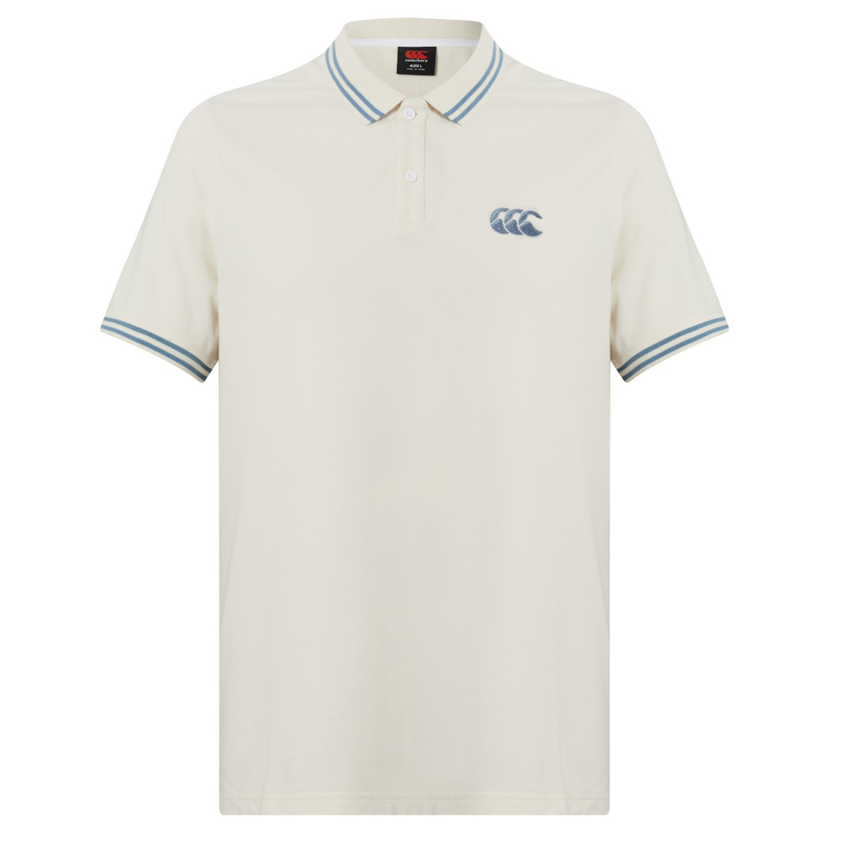 The Canterbury Fundamental Solid Dye Polo is cream-colored with a rugby-inspired look, featuring blue and white striped collar and cuffs, plus a blue logo on the left chest.