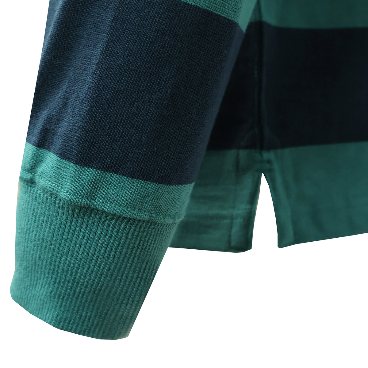 Close-up of the Canterbury Fundamental Yarn Dye Stripe Long Sleeve Rugby Jersey in dark green and navy, highlighting its cuff, hem, and side slit—classic rugby-inspired details from Canterbury.