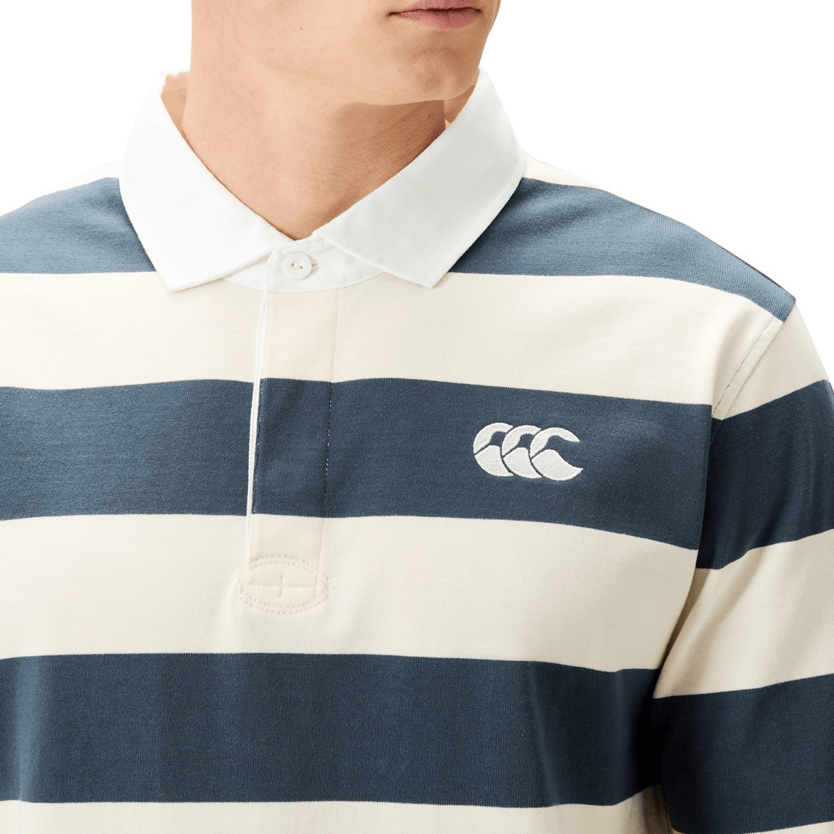 Wearing the Canterbury Yarn Stripe Rugby Jersey by Canterbury, featuring cream and blue yarn-dyed stripes, long sleeves, a collared neckline, and a small embroidered chest logo.