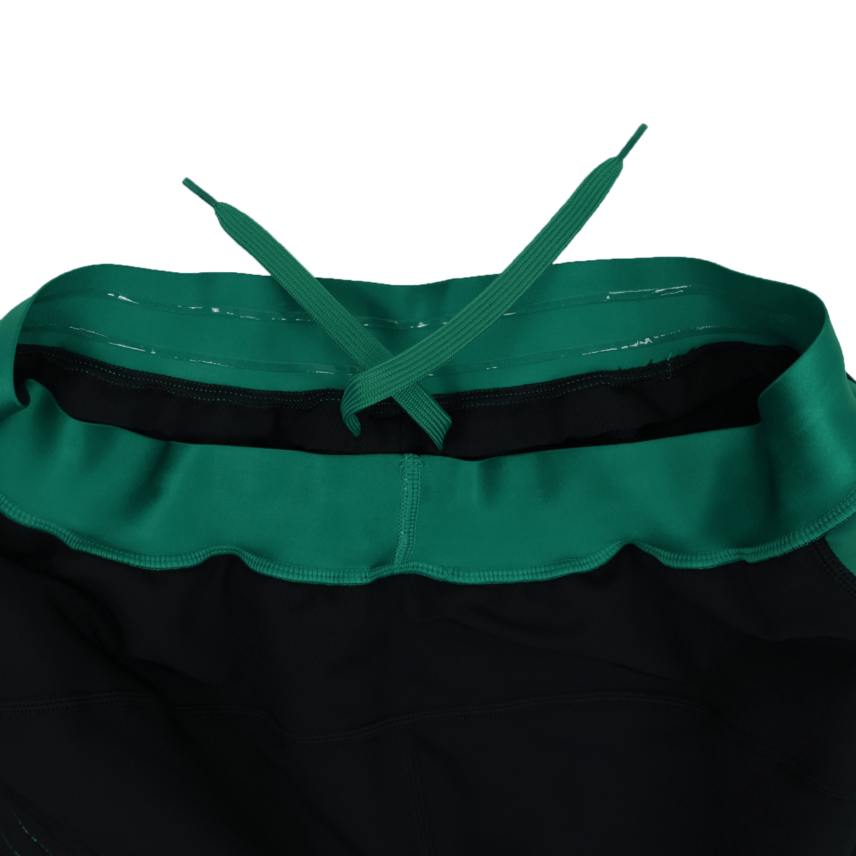 Close-up of the waistband and drawstring of the Canterbury Ireland 25/26 Alternate Match Short, featuring a green waistband on black rugby shorts, viewed from above.