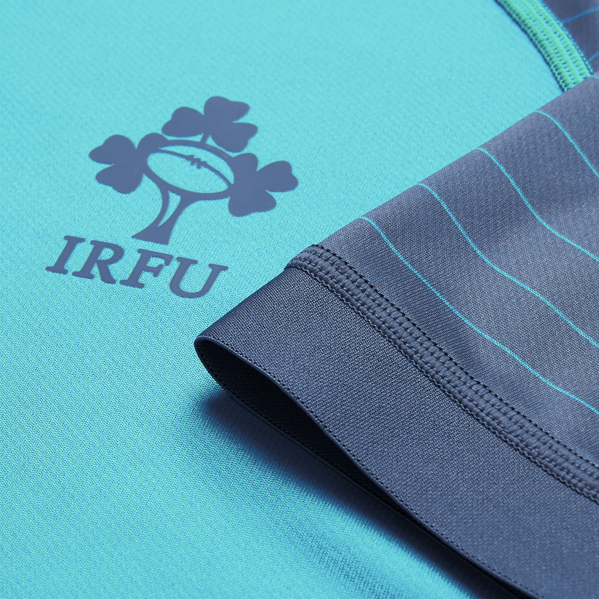 Close-up of the Ireland 26/27 Summer Tour Training Pro Jersey by Canterbury, featuring teal and navy colors, the rugby ball in a shamrock emblem, and Canterbury’s signature Pro Fit design.