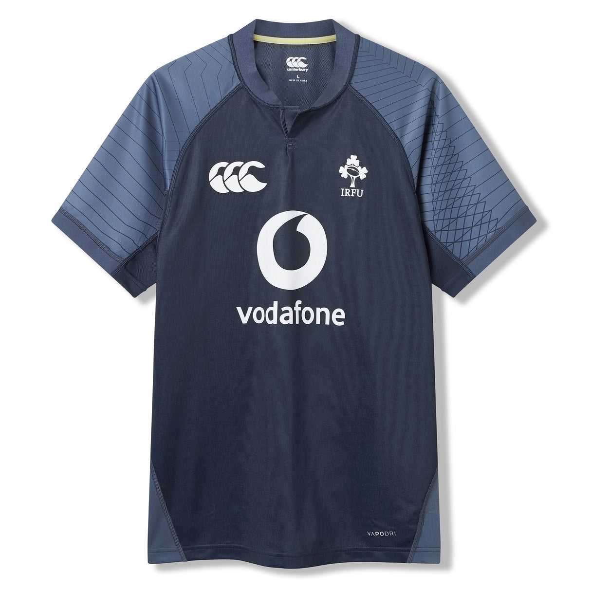 The Ireland 26 Training Pro Jersey by Canterbury is a navy blue rugby top with short sleeves, Vodafone sponsor, and IRFU chest logo, featuring patterned shoulder panels. Displayed on a white background, this Canterbury jersey is crafted with innovative VapoDri fabric for superior comfort and performance.