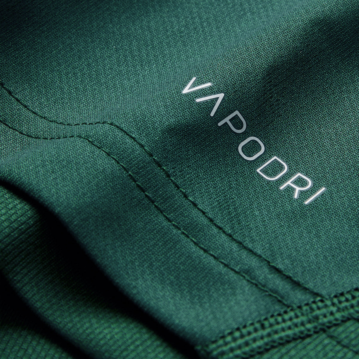 Close-up of green fabric with visible stitching and the word “VAPODRI” printed in white text, highlighting the premium quality of the Ireland 26 Training Pro Jersey by Canterbury.