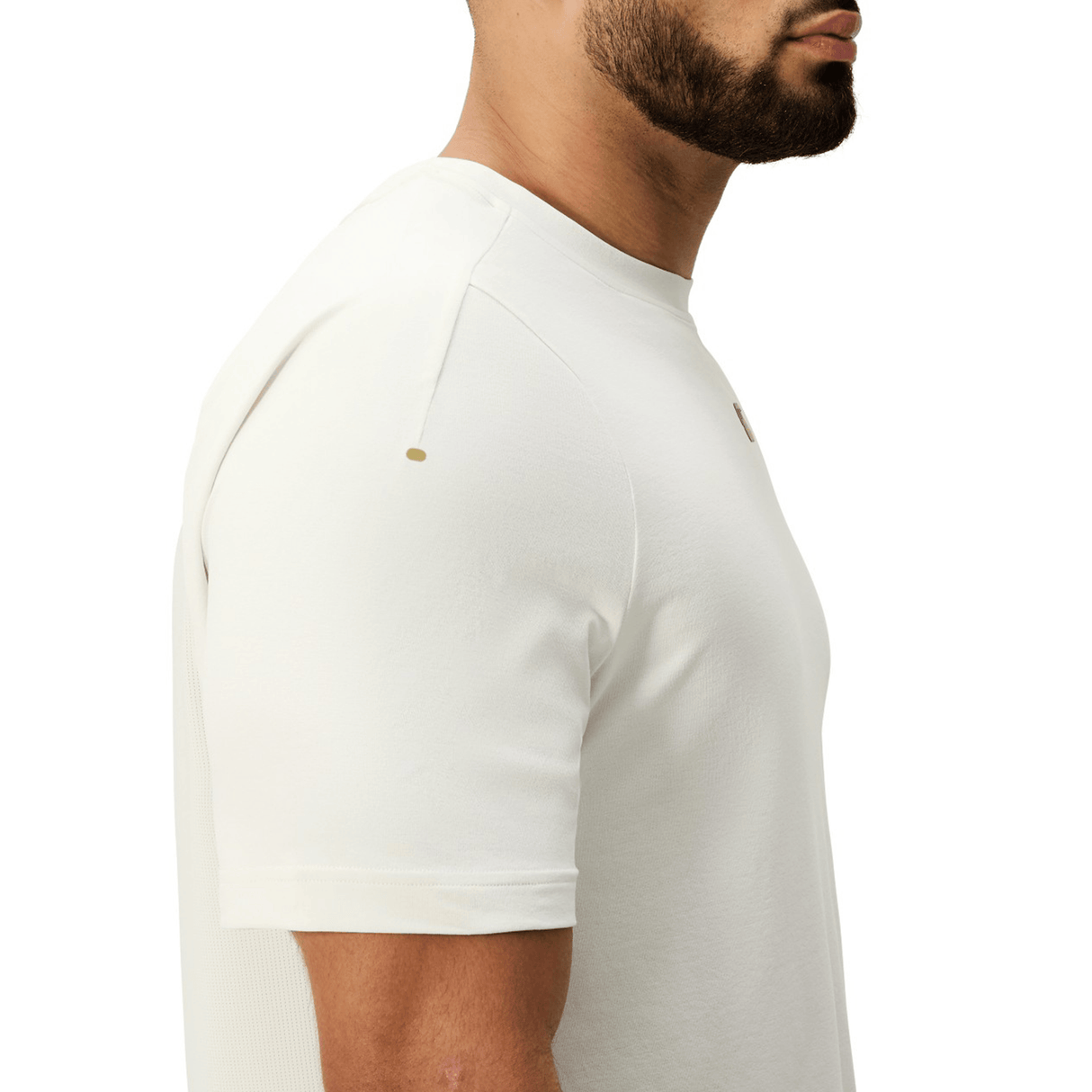 A man models the Canterbury Everest Dart Tech T-Shirt in white, shown from the side with his head partially cropped, set against a plain white background.