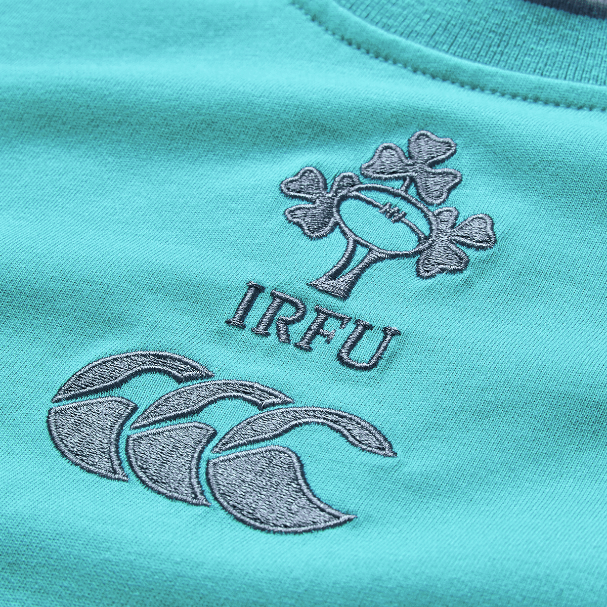 Close-up of the Ireland 26/27 Summer Tour Team Cotton T-Shirt by Canterbury, showcasing the embroidered IRFU shamrock, rugby ball, and Canterbury logo—ideal for fans preparing for the summer tour.