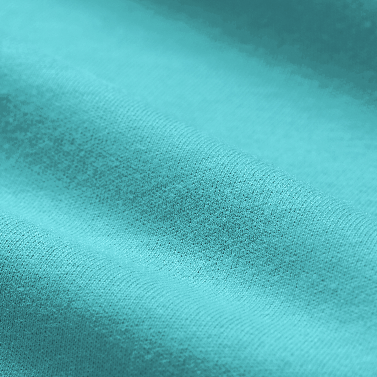 Close-up of light blue fabric with visible texture and soft folds, inspired by the Ireland 26/27 Summer Tour Team Cotton T-Shirt by Canterbury.