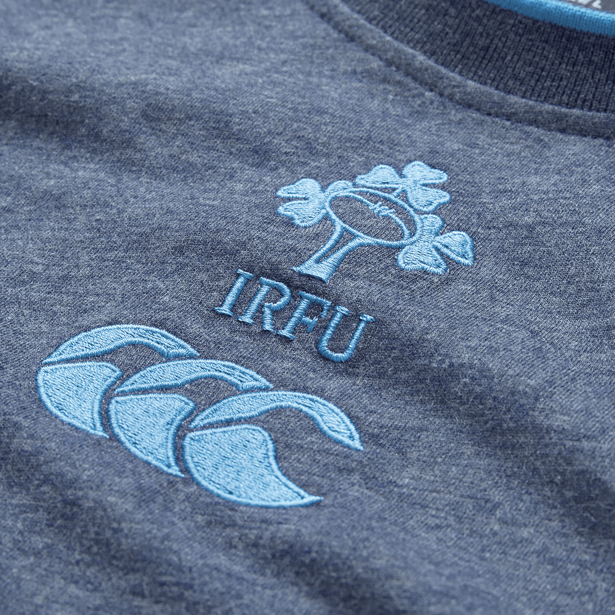 Show your support with the Ireland 26/27 Summer Tour Team Cotton T-Shirt by Canterbury, featuring embroidered IRFU text, a shamrock emblem, and three wave detail—ideal for any Ireland Rugby fan.
