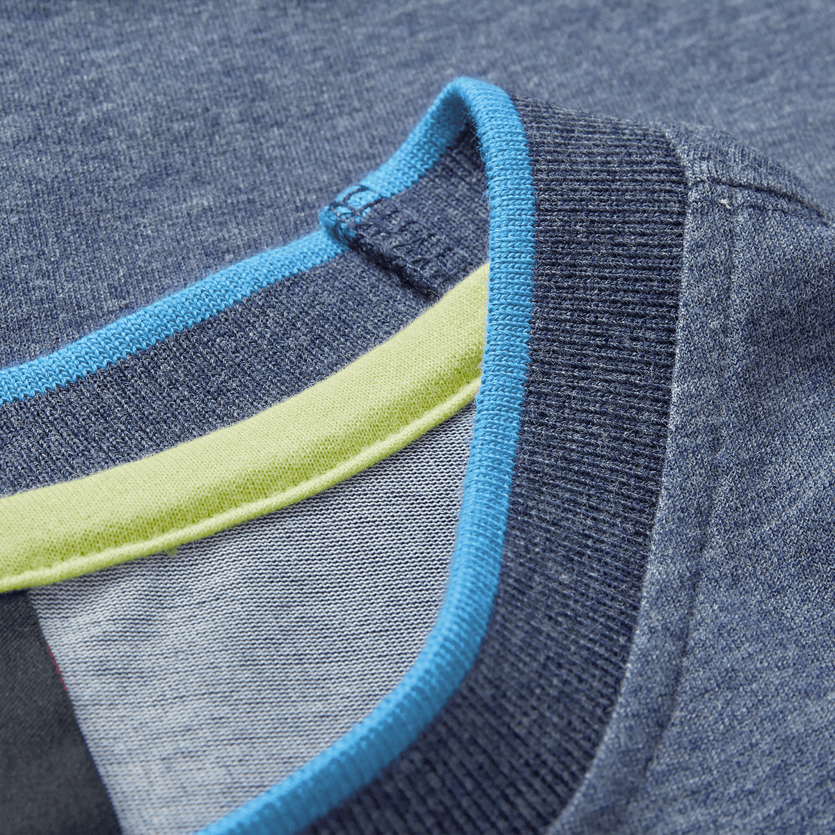 Close-up of the Ireland 26/27 Summer Tour Team Cotton T-Shirt by Canterbury, featuring a blue collar with ribbed navy trim and light blue and green accents inside—an ideal choice for your summer tour.