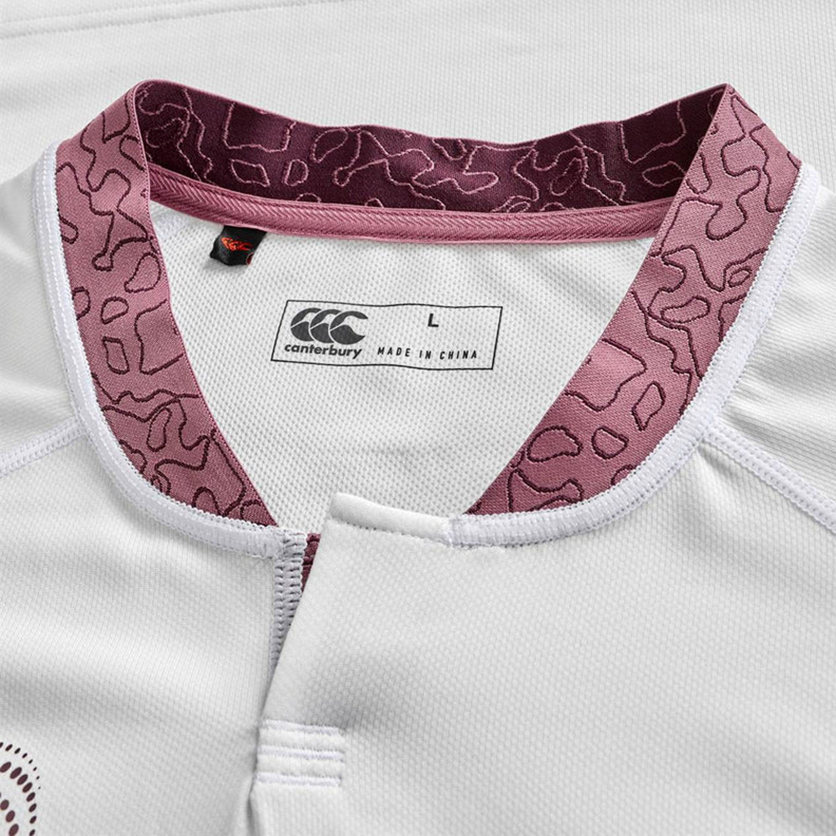 Close-up of the Ireland WRWC25 Replica Alternate Jersey by Canterbury, showing a maroon patterned collar, brand tag, and size label marked "L, made in China.