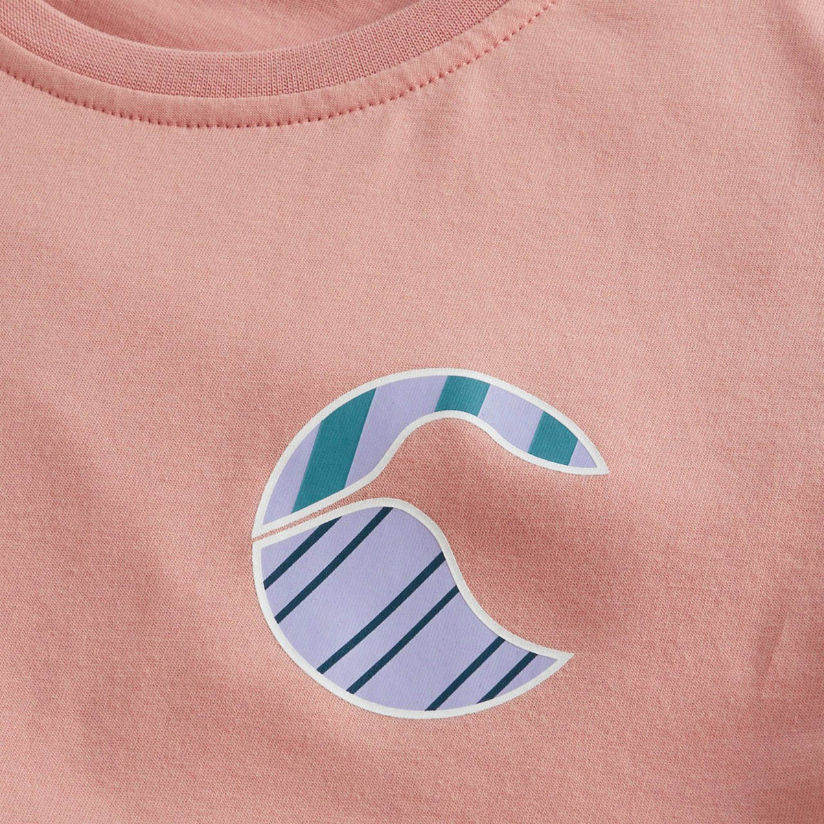 The Canterbury Women’s Canterbury Uglies Logo T-Shirt features a light pink base with a bold stylized wave graphic on the front, accented by teal and purple diagonal stripes across the upper and lower sections—an ideal choice for anyone looking to add a sporty flair to a classic women’s rugby tee.
