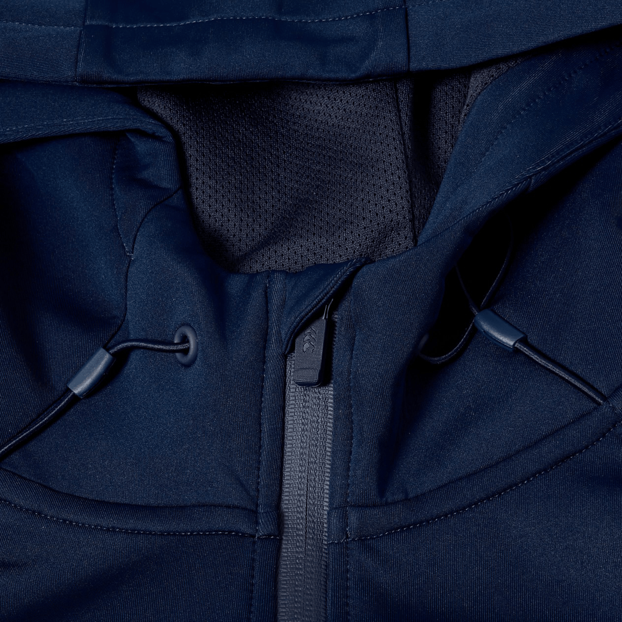 Close-up of a navy blue Canterbury Everest Full Zip Hoodie by Canterbury, highlighting the zipper, drawstrings, and part of the hood with mesh lining.