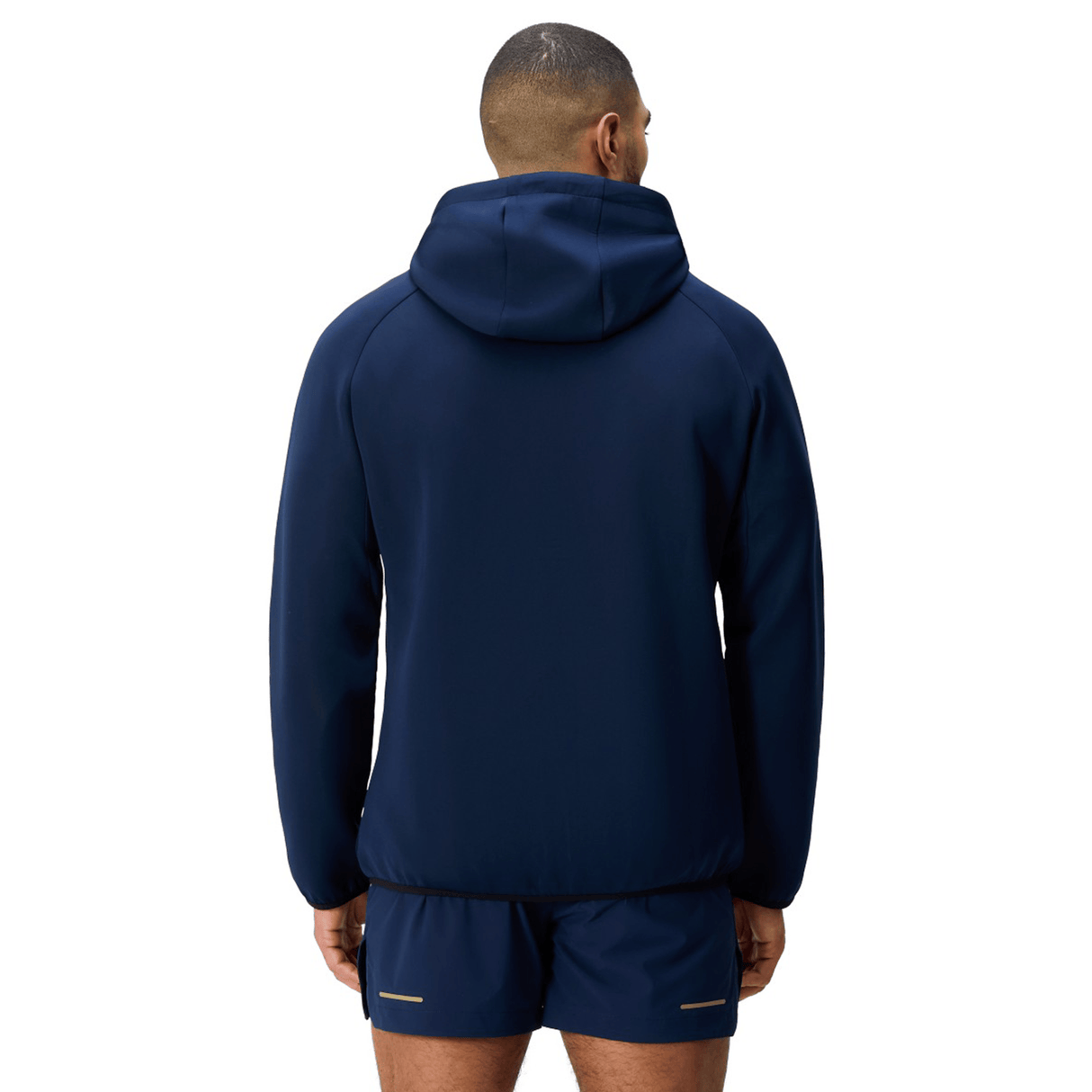 A man faces away, wearing the Canterbury Everest Full Zip Hoodie with matching navy shorts—a performance hoodie by Canterbury—set against a plain white background.