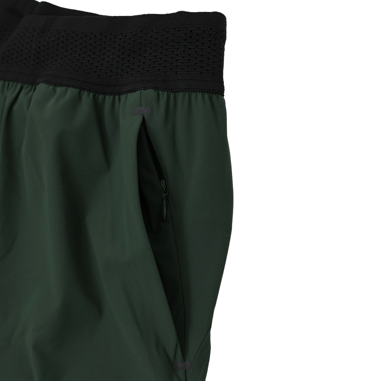 Close-up of the Canterbury Everest Woven Short 5" by Canterbury, a green training short with black elastic waistband, zippered side pocket, and four-way stretch fabric for optimal comfort.