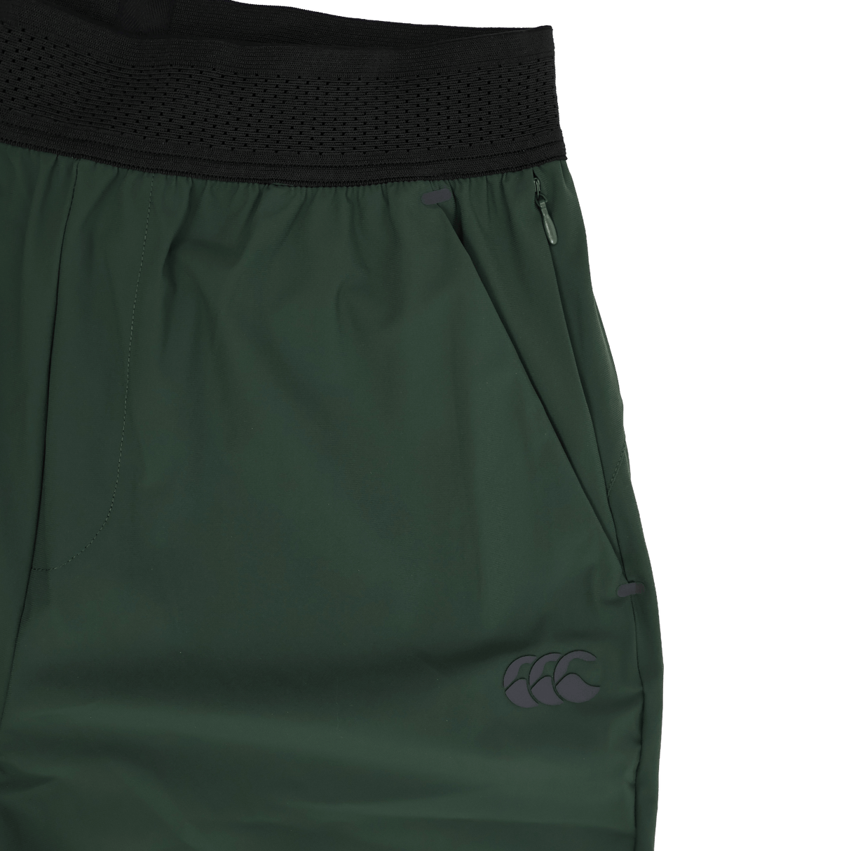 Close-up of the Canterbury Everest Woven Pant 30" by Canterbury, featuring a black waistband, zippered pocket, small logo on the lower leg, and crafted from four-way stretch fabric for comfort and flexibility.