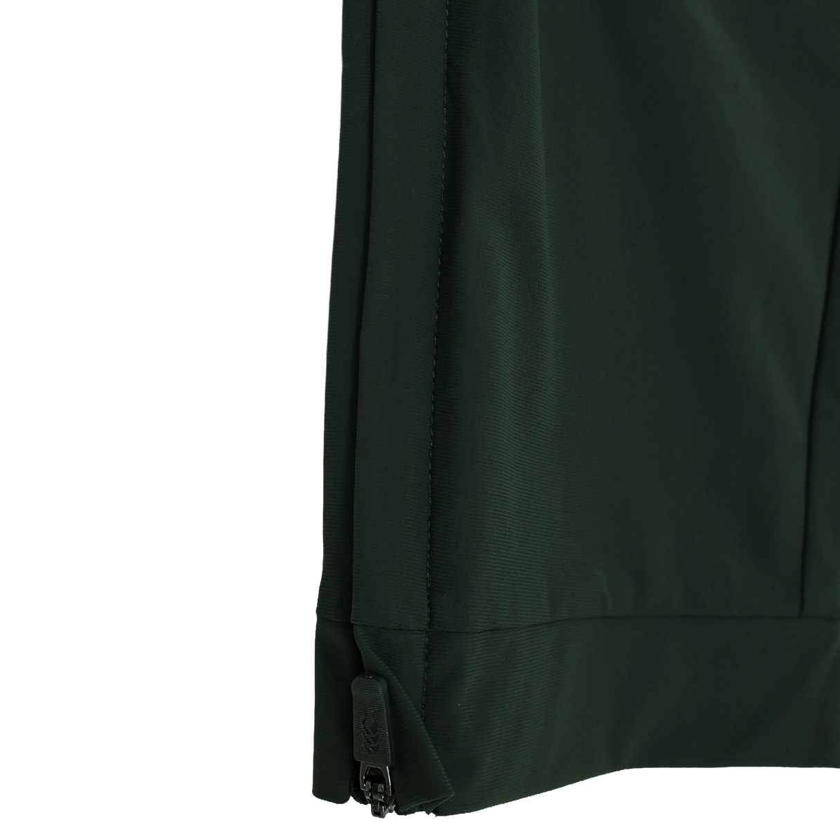 Close-up of the lower edge of a dark green Canterbury Everest Woven Pant 30" by Canterbury, highlighting the black zipper along the side seam and four-way stretch fabric, set against a white background.