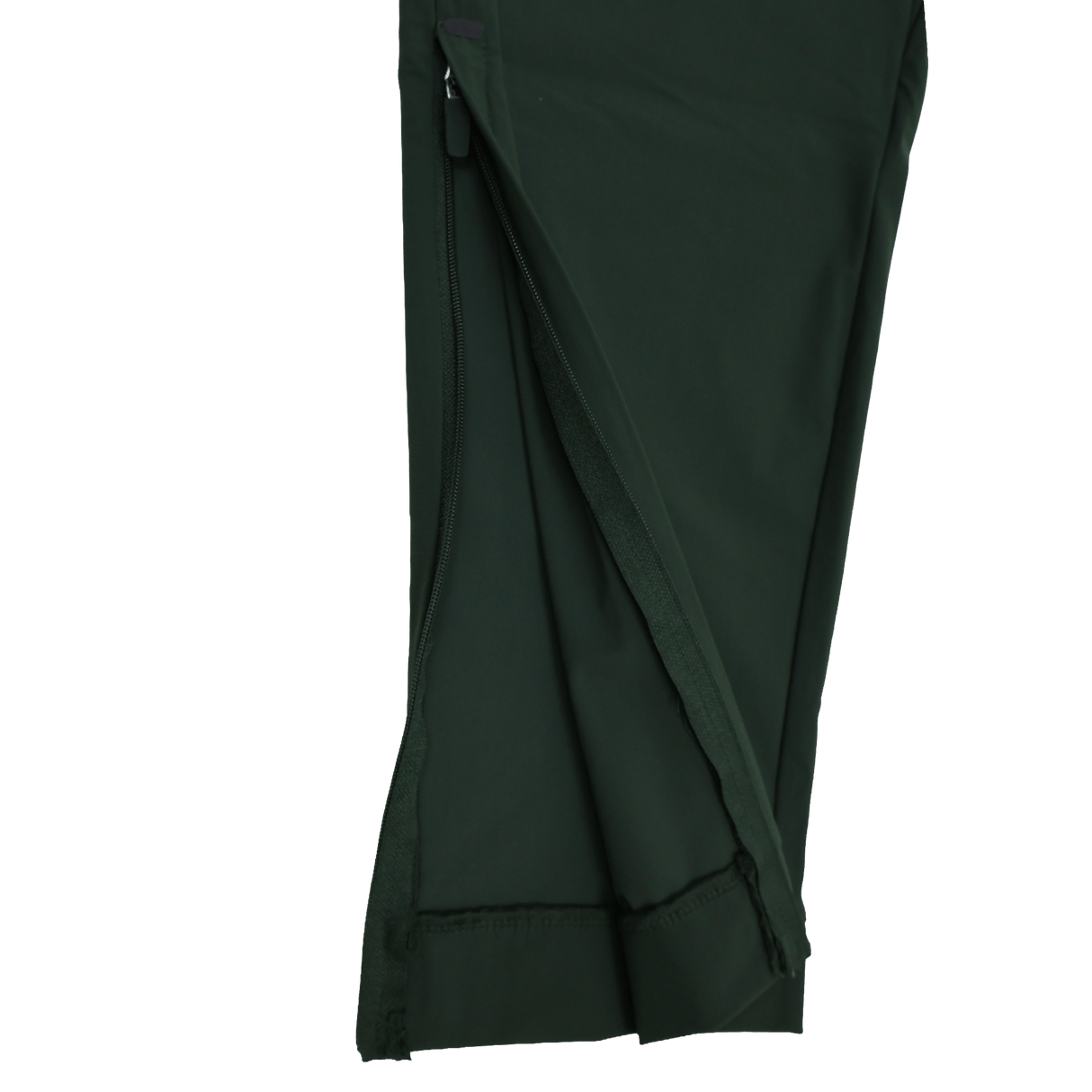 Close-up of the Canterbury Everest Woven Pant 30" leg in dark green, showing a partially unzipped seam with visible inner fabric and stitching. This pant features sweat-wicking comfort and four-way stretch for easy movement.