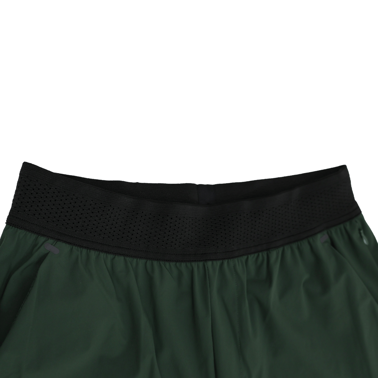 Close-up of the waistband on Canterbury Everest Woven Pant 30" by Canterbury, featuring a black perforated elastic band with sweat-wicking and four-way stretch properties, shown against a white background.