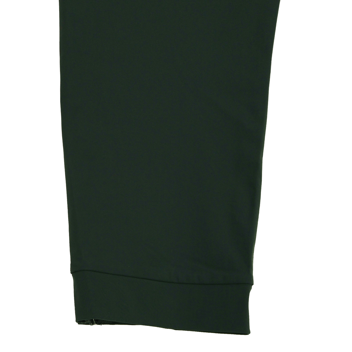 Close-up of the Canterbury Everest Woven Pant 30" in dark green by Canterbury, showing its cuffed hem and four-way stretch fabric, set against a plain white background.