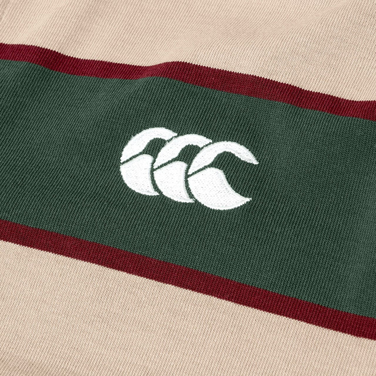 The Canterbury Stripe Rugby Jersey, in beige and green, features a white embroidered Canterbury rugby logo at the center.