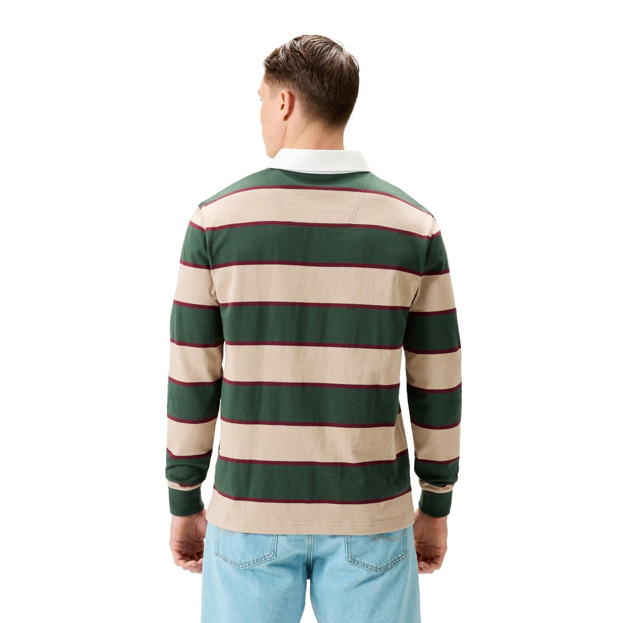 A man stands with his back to the camera, wearing a Canterbury Stripe Rugby Jersey in green and beige with a white collar, paired with light blue jeans.