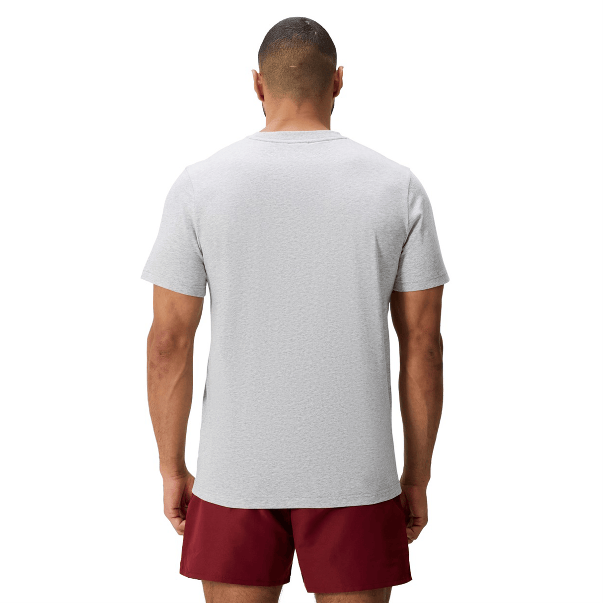 A man, seen from behind, wears a light gray Canterbury Uglies Logo T-shirt and maroon shorts against a plain white background.