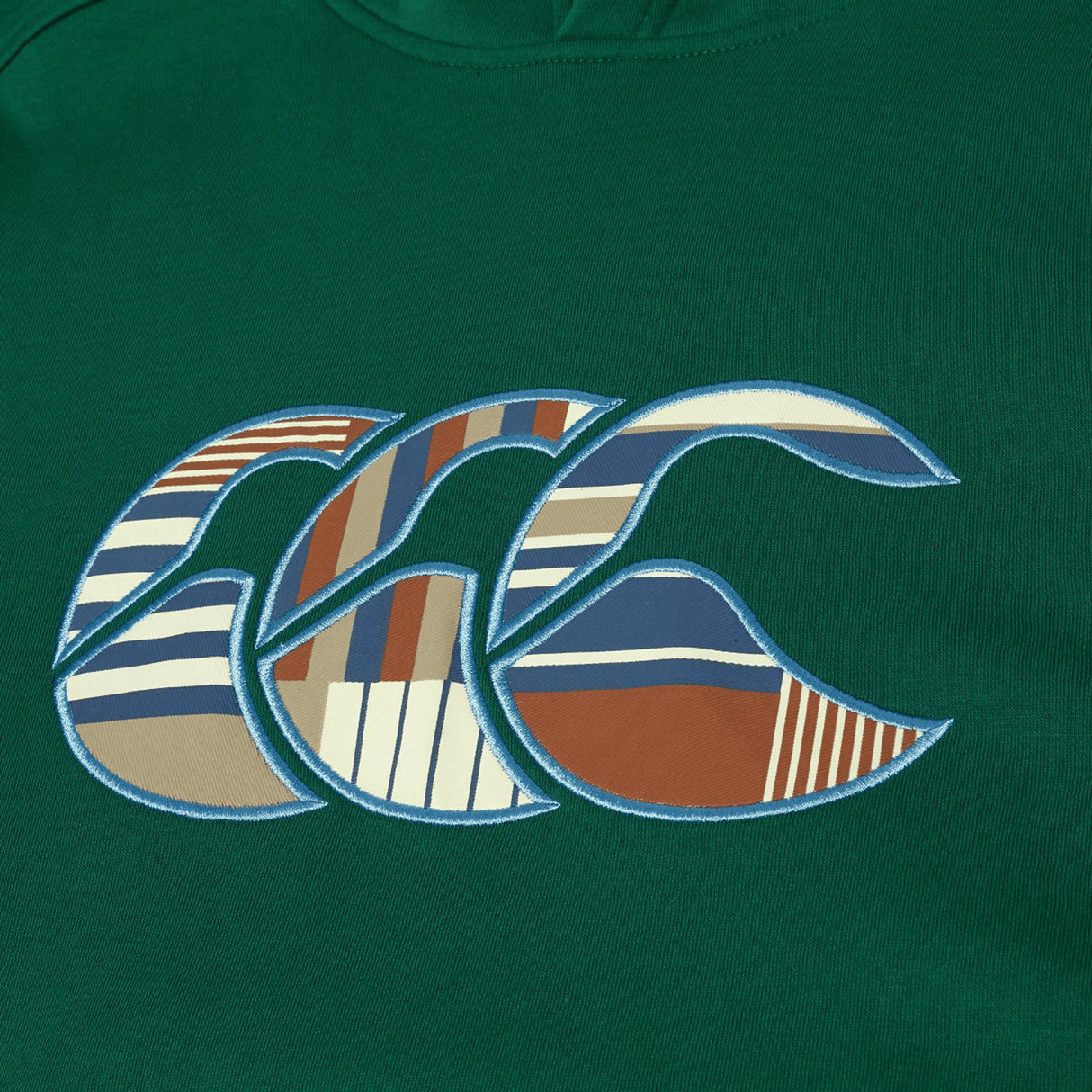 The Canterbury Uglies Logo Hoodie by Canterbury is a green rugby hoodie featuring a large "CCC" logo in blue, brown, white, and tan geometric patterns.