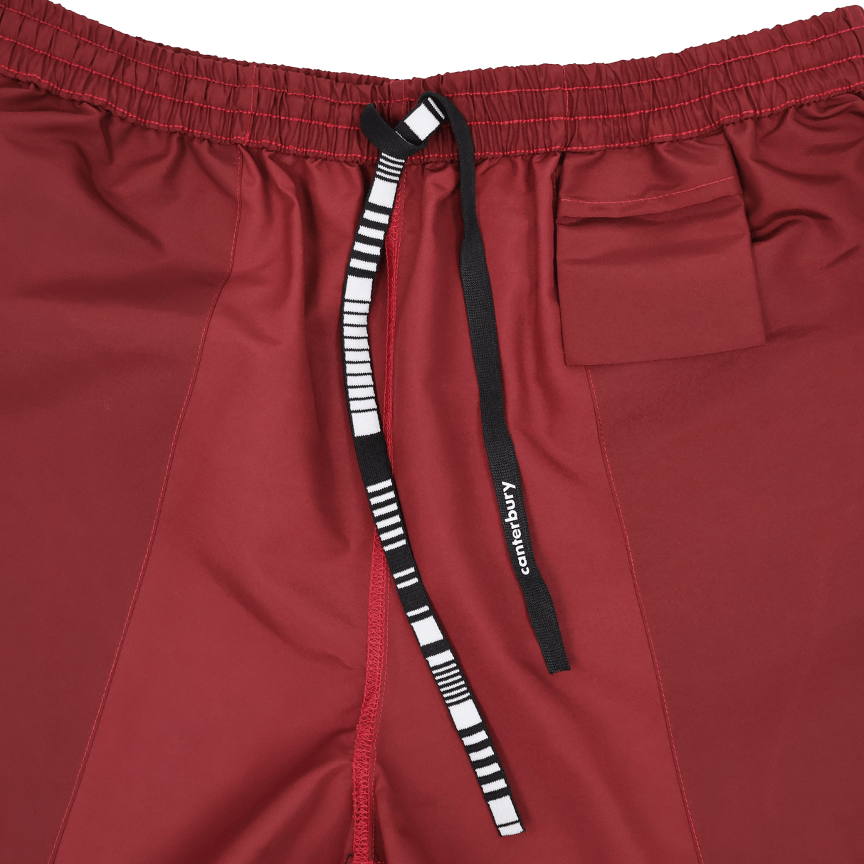 Close-up of Canterbury Uglies 5" Tactic Short in maroon, featuring an elastic waistband, small pocket, and black-and-white "Canterbury" drawstring. Durable rugby shorts designed for training performance.