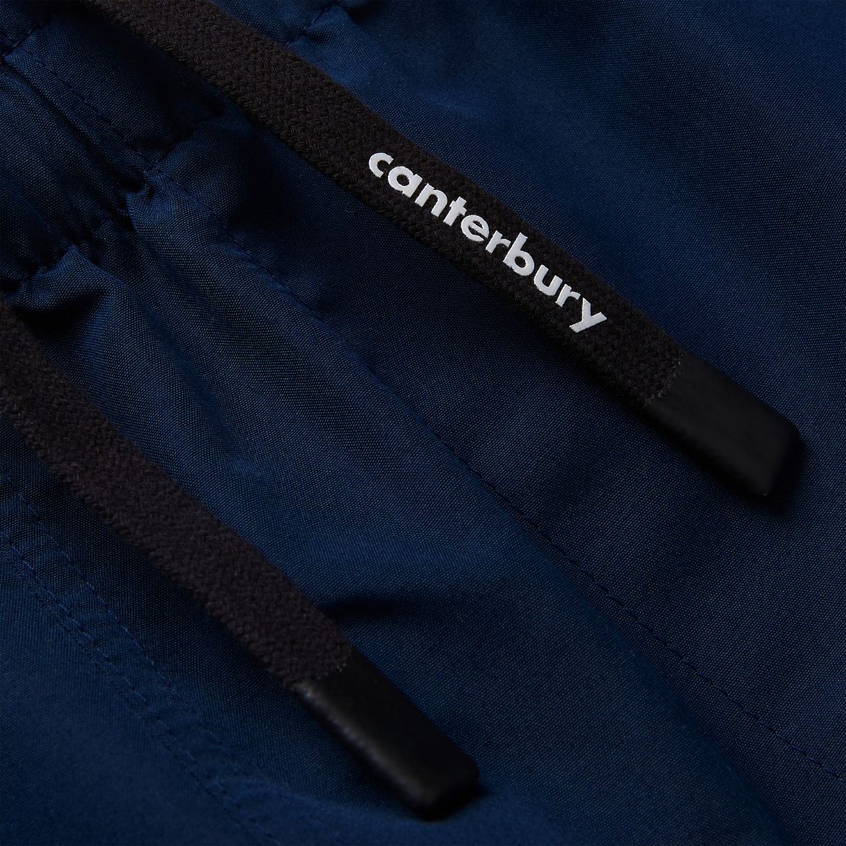 Close-up of Women's Canterbury Uglies Tactic Short—dark blue performance training shorts with black drawstrings and "Canterbury" in white, ideal for women's rugby, from the Canterbury Uglies collection.