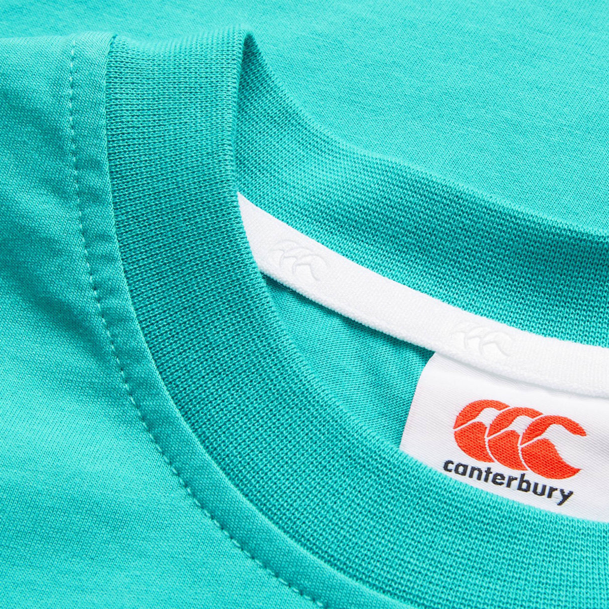 Close-up of the collar and label on the Youth Canterbury Uglies Logo T-shirt by Canterbury, highlighting the brand logo and stitching details—ideal for fans of this iconic youth rugby t-shirt collection.