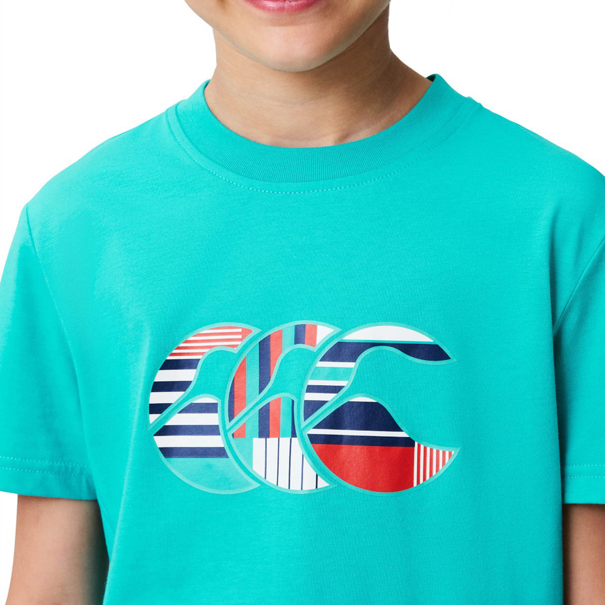 A child wearing a turquoise Youth Canterbury Uglies Logo T-shirt by Canterbury, featuring a graphic design of two stylized, multicolored waves on the chest.