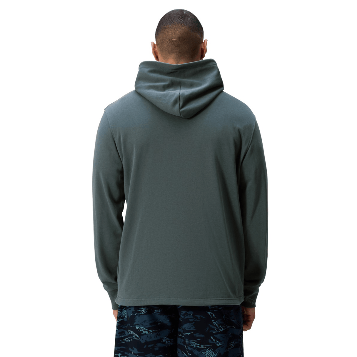 A person models the Canterbury FORCE HOODIE in green with dark patterned shorts, standing with their back to the camera against a white background.