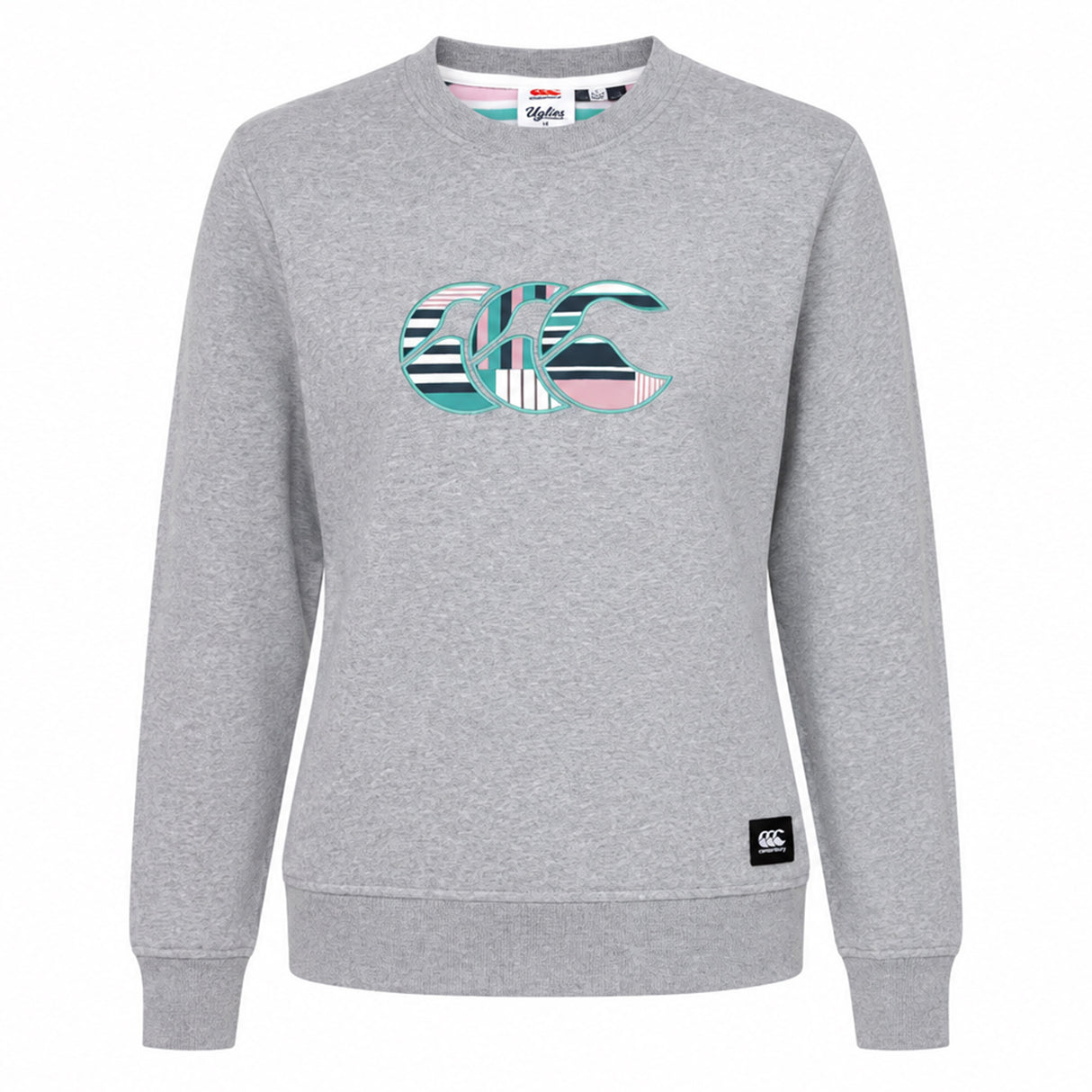 The Canterbury Women's Uglies Logo Crew Sweatshirt features a light grey crewneck design with a vibrant multicolored striped "CCC" logo on the chest, taking inspiration from the iconic Canterbury Uglies sweatshirt. Finished with a small black logo patch on the lower left hem, this must-have women's rugby sweatshirt by Canterbury blends laidback style and athletic heritage.