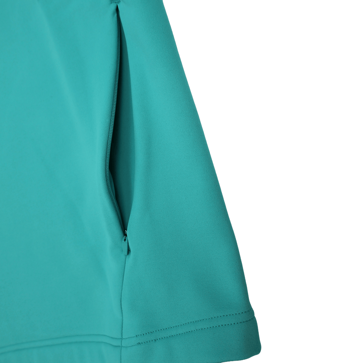 Close-up of the Ireland 26/27 Summer Tour Training Hoodie by Canterbury in teal, showcasing a zippered side pocket, precise stitching, and smooth moisture-wicking fabric.