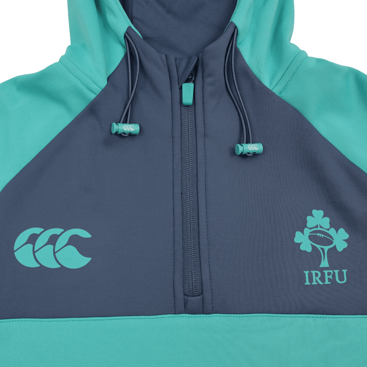 The Ireland 26/27 Summer Tour Training Hoodie by Canterbury features a teal and navy design, quarter zip, moisture-wicking fabric, and IRFU and Canterbury logos—ideal for fans of the Ireland Summer Tour.