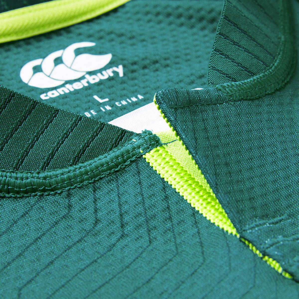 Close-up of the Ireland 26 Home Test Jersey by Canterbury in green, highlighting the collar, stitching details, and Canterbury logo with “Made in China” text—a classic design inspired by traditional Ireland Test Jerseys.