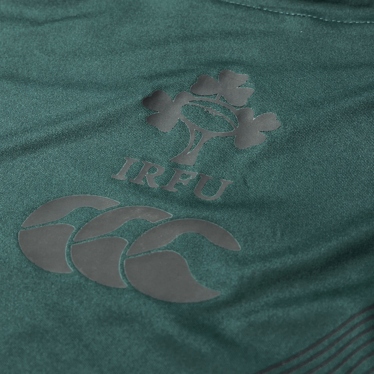 Close-up of a green Ireland 26 Training Tank by Canterbury AW26, featuring the IRFU logo with a rugby ball and shamrock leaves, along with the Canterbury brand logo beneath it; this training tank is crafted for comfort and performance in every session.