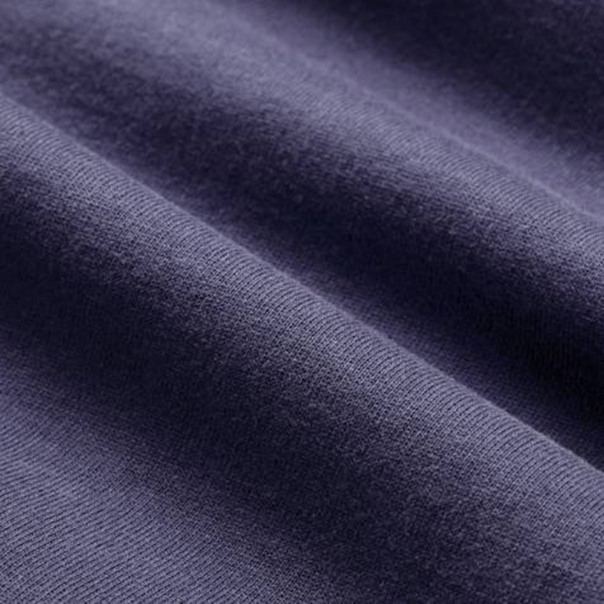 Close-up of a purple fabric with a soft, smooth texture and visible horizontal folds, reflecting the premium quality of the Women’s Ireland 26 Cotton T-shirt by Canterbury.