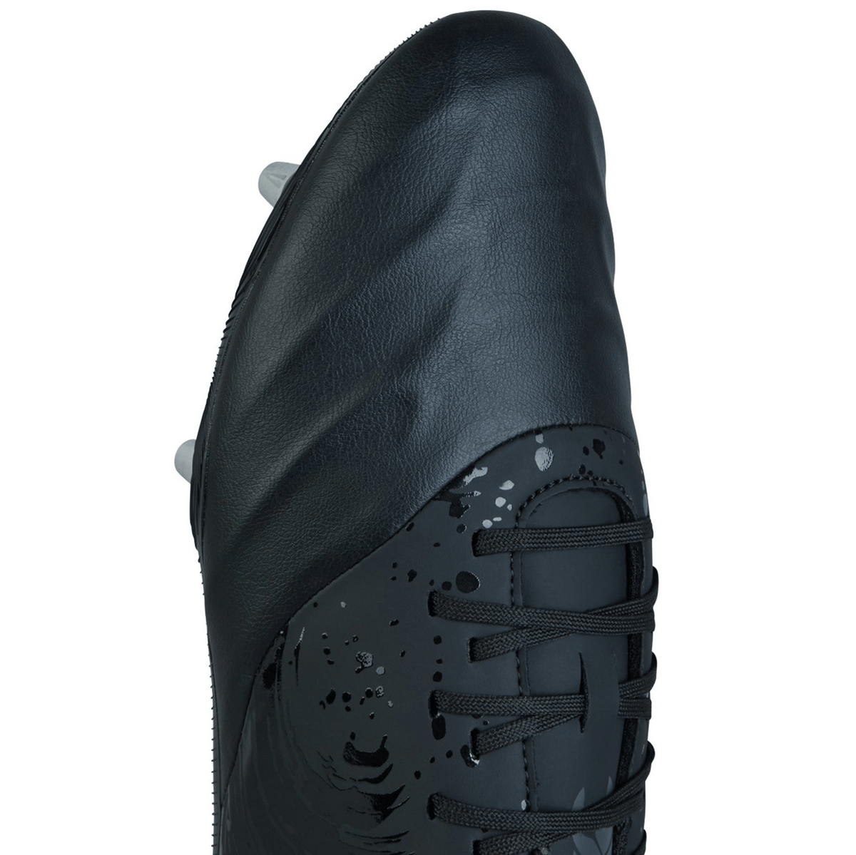 Close-up image of the Canterbury Phoenix Genesis Team SG rugby boot by Canterbury, highlighting the black and silver metallic design with textured sides, detailed laces, and metal studs on the underside.