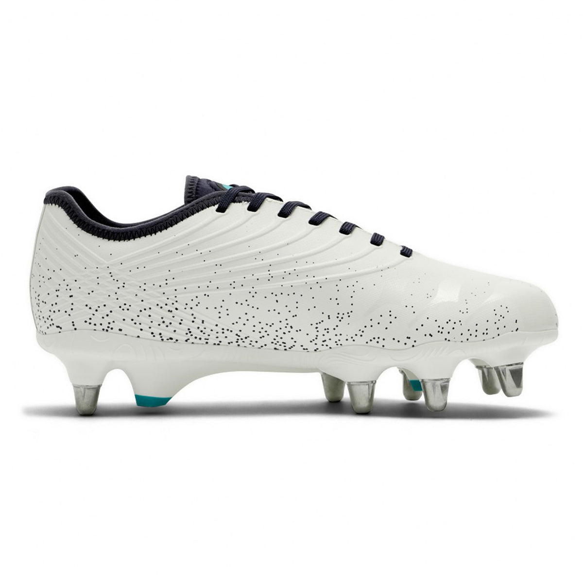The Canterbury Stampede Groundbreak Pro SG rugby boots in white and Baltic green feature a striking black speckled design, black laces, and six silver metal studs on the sole—making them ideal soft ground boots for powerful scrummaging. Displayed against a white background.