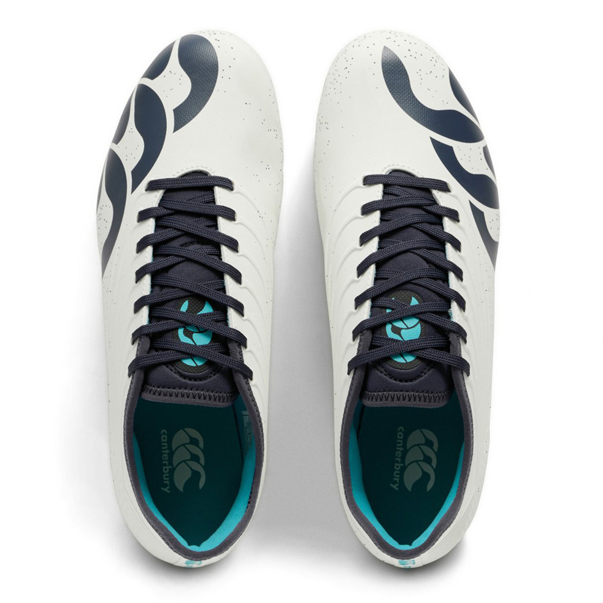 A pair of Canterbury Stampede Groundbreak Pro SG rugby boots in white and baltic green, featuring black laces and bold black graphic designs, viewed from above. Teal accents inside the shoes add a distinctive and dynamic touch to these soft ground boots.