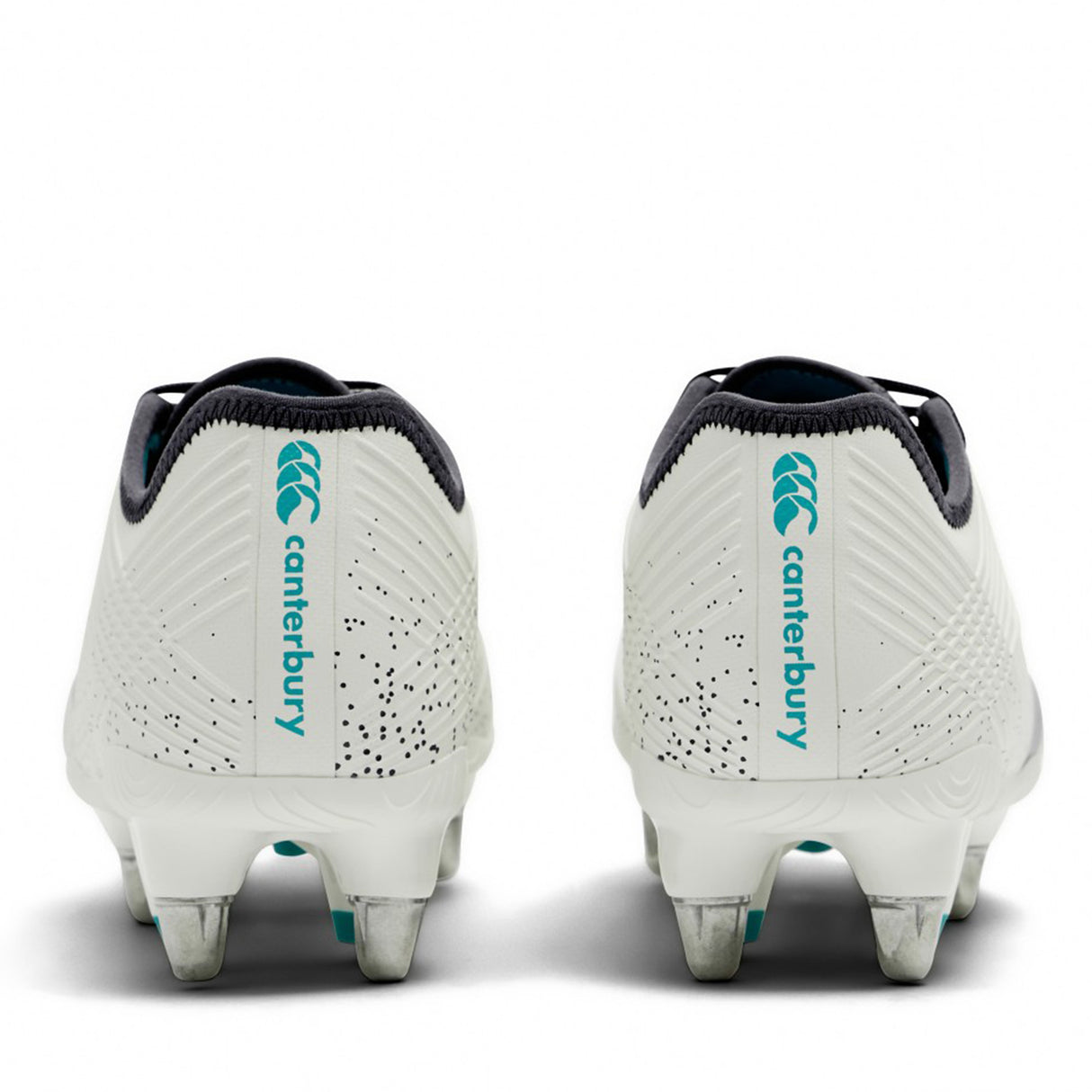 A pair of Canterbury Stampede Groundbreak Pro SG rugby boots in white and baltic green, designed for soft ground with metal studs, shown from the back and displaying the teal Canterbury logo and branding.