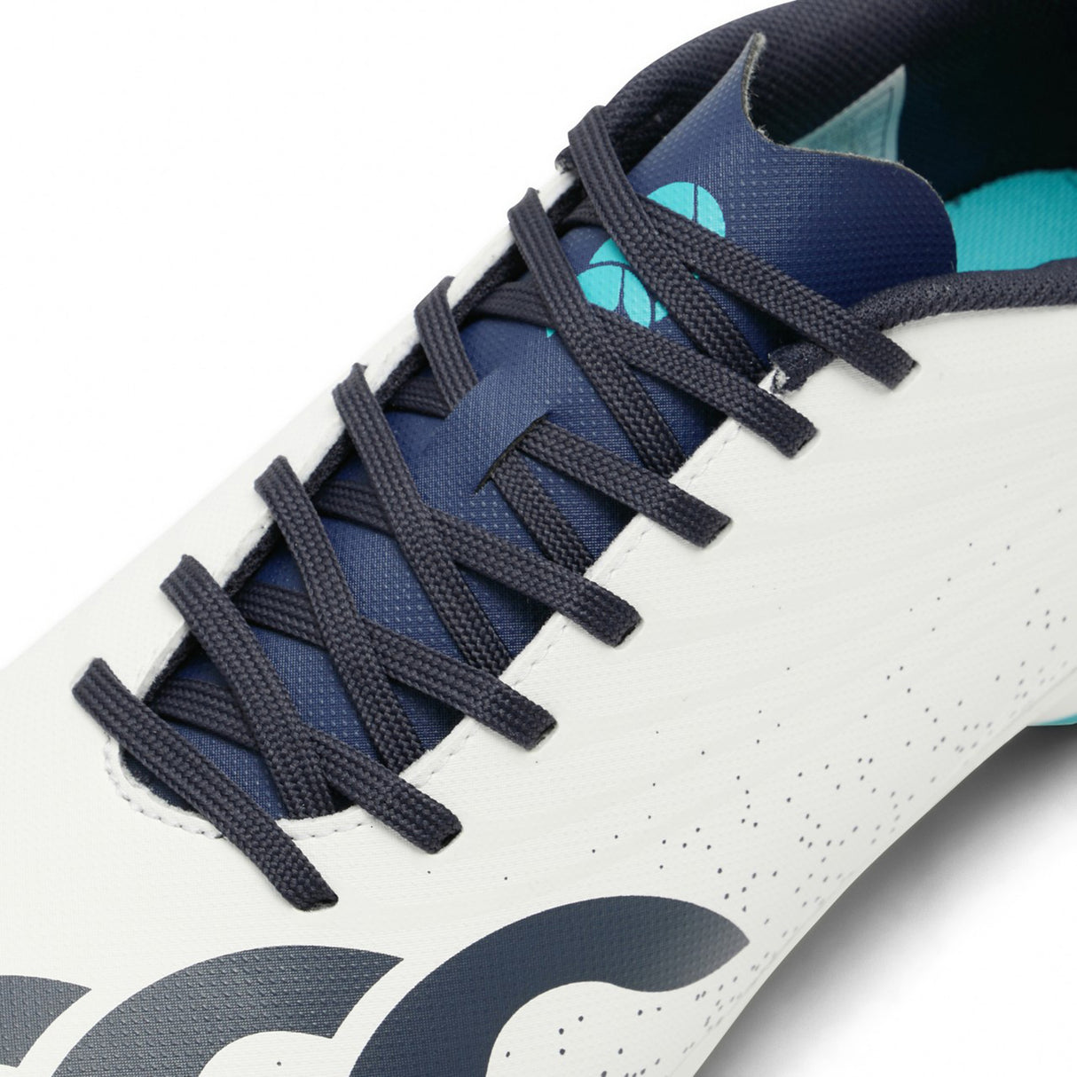 Close-up of the Canterbury Stampede Groundbreak Team SG rugby boot in white and Baltic Green, designed for forwards and ideal for soft ground, featuring dark blue laces, navy detailing, and a partially visible blue interior.