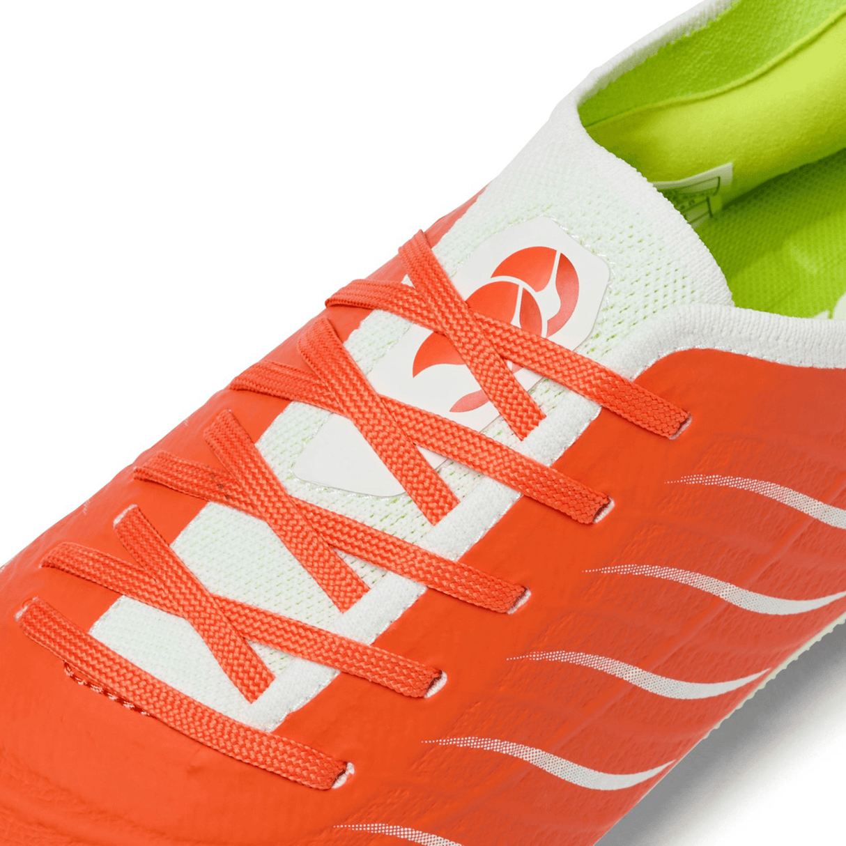 Close-up of Canterbury Phoenix 2.0 Elite SG rugby boot by Canterbury, featuring a tangerine tango and snow white design with orange laces and a green interior lining.
