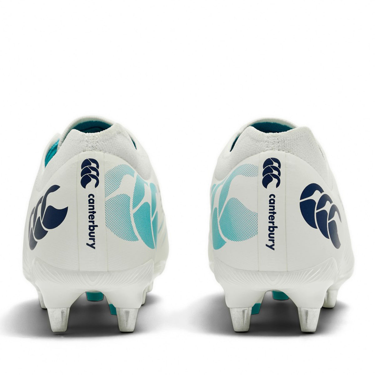 A pair of Canterbury Phoenix 2.0 Pro SG rugby boots in White/Baltic Green, shown from the back with metallic studs and a textured heel design, featuring bold Canterbury branding—ideal soft ground boots for forwards looking for superior grip and stability.