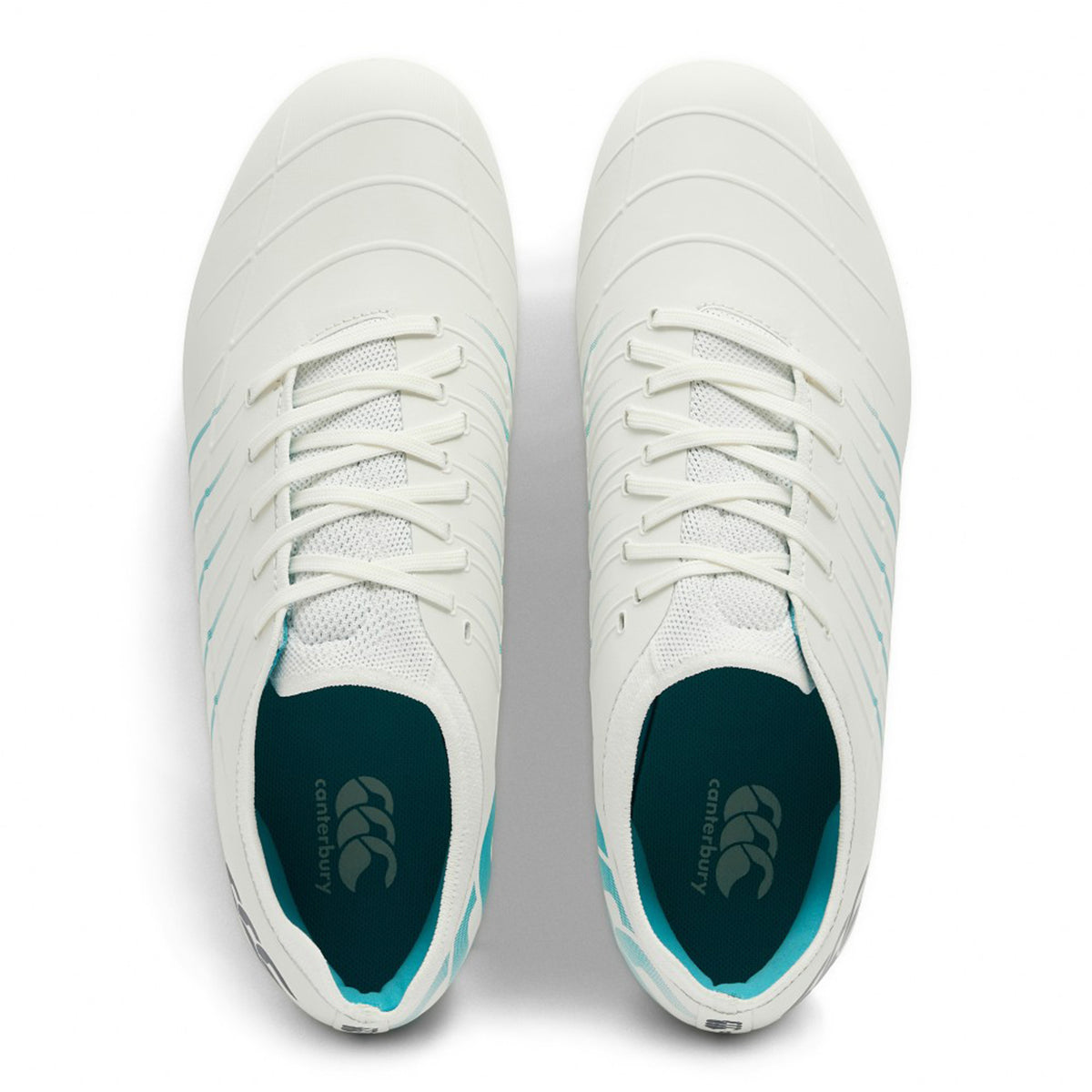 A pair of Canterbury Phoenix 2.0 Pro SG rugby boots in White/Baltic Green, viewed from above, featuring laces and the Canterbury brand logo on the insoles. Designed for forwards, these soft ground boots offer optimal traction and support during intense matches.