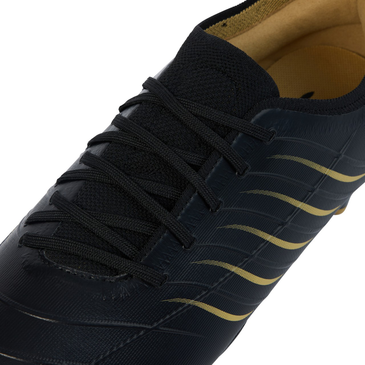 Close-up of the Canterbury Phoenix 2.0 Pro FG - Black, an athletic shoe featuring black laces and gold diagonal stripes on the side, highlighting its lightweight power along with portions of its upper and inner lining.