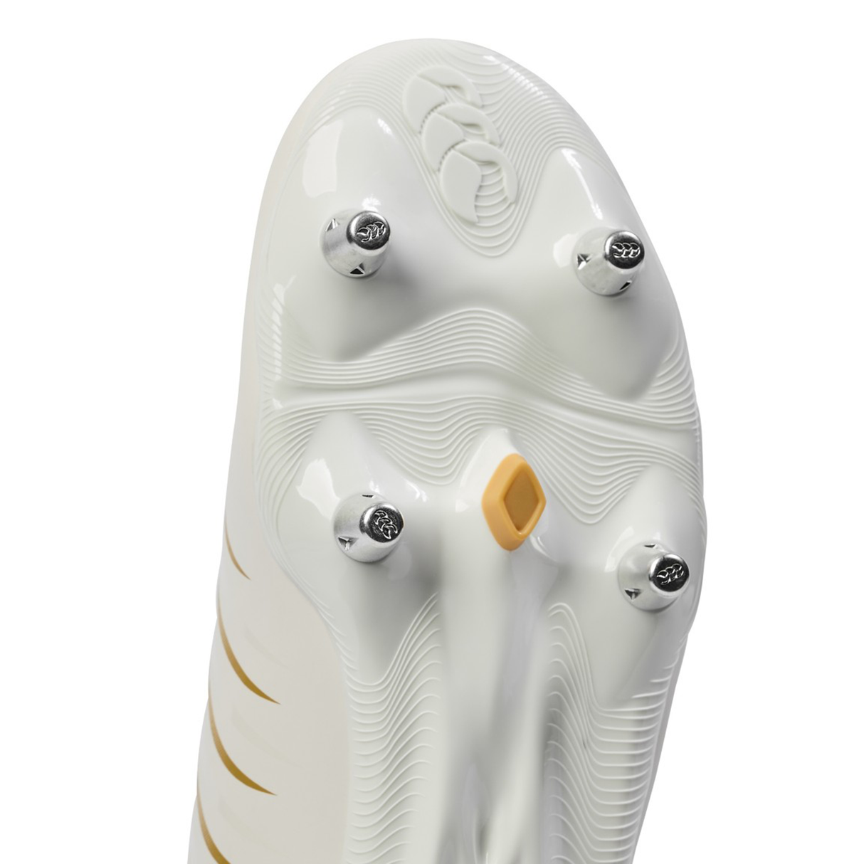 Close-up of the sole of the Canterbury Phoenix 2.0 Team SG - White rugby boot by Canterbury, featuring four metal studs and a yellow accent for optimal grip on soft ground rugby pitches.