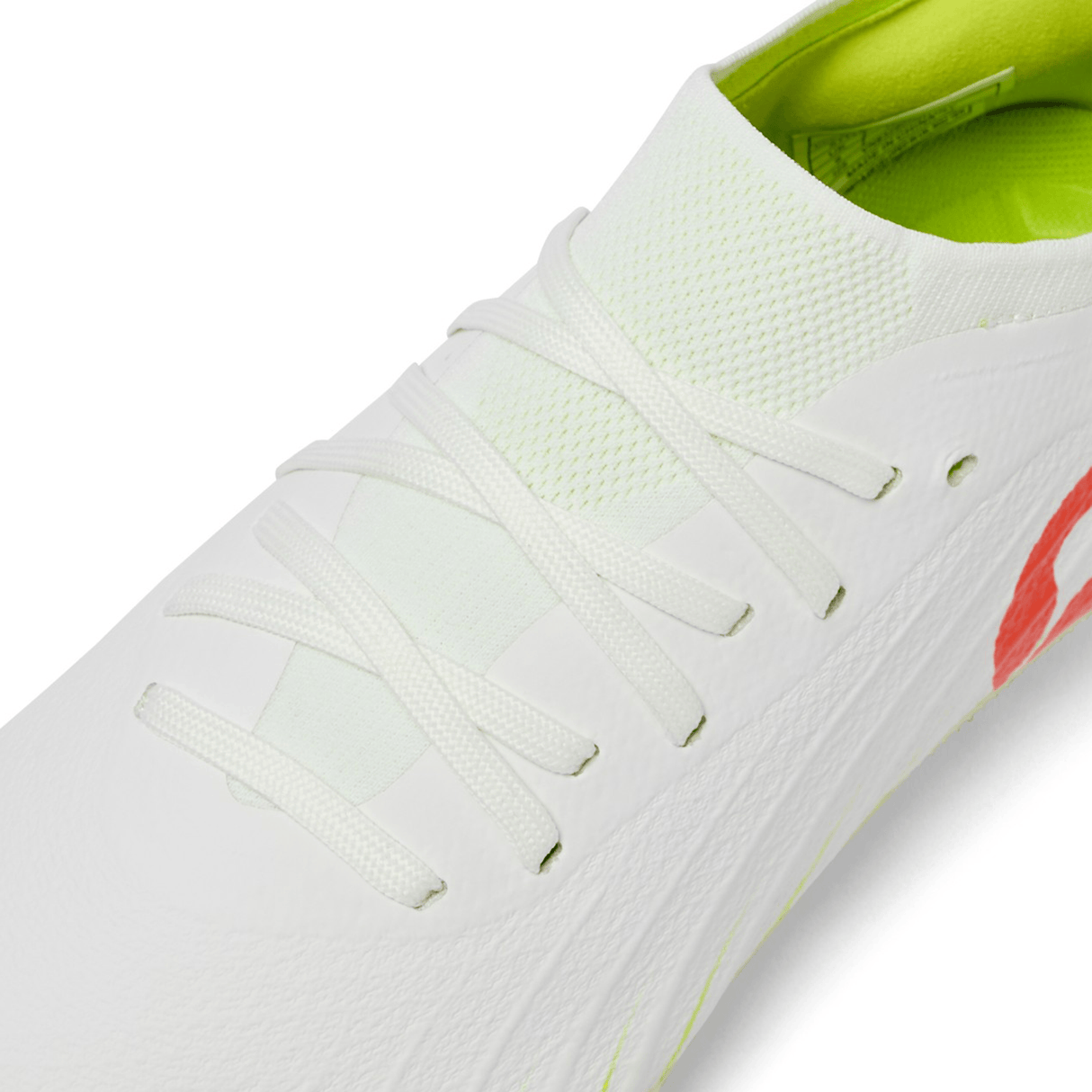 Close-up of the Canterbury Speed Falcon Elite SG - Snow White/Tangerine Tango: a white rugby boot with white laces, textured upper, neon green lining, and elite soft ground performance design.