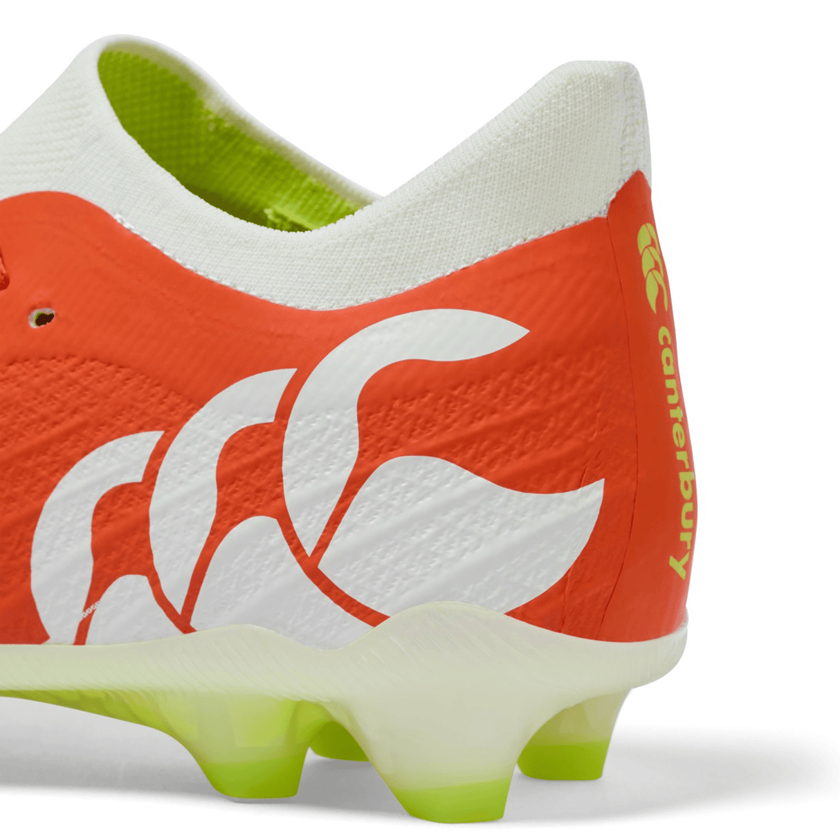 Close-up of the Canterbury Speed Falcon Elite FG in Tangerine Tango/Snow White, highlighting lime green and white sole studs—a top choice for players wanting lightweight football boots.