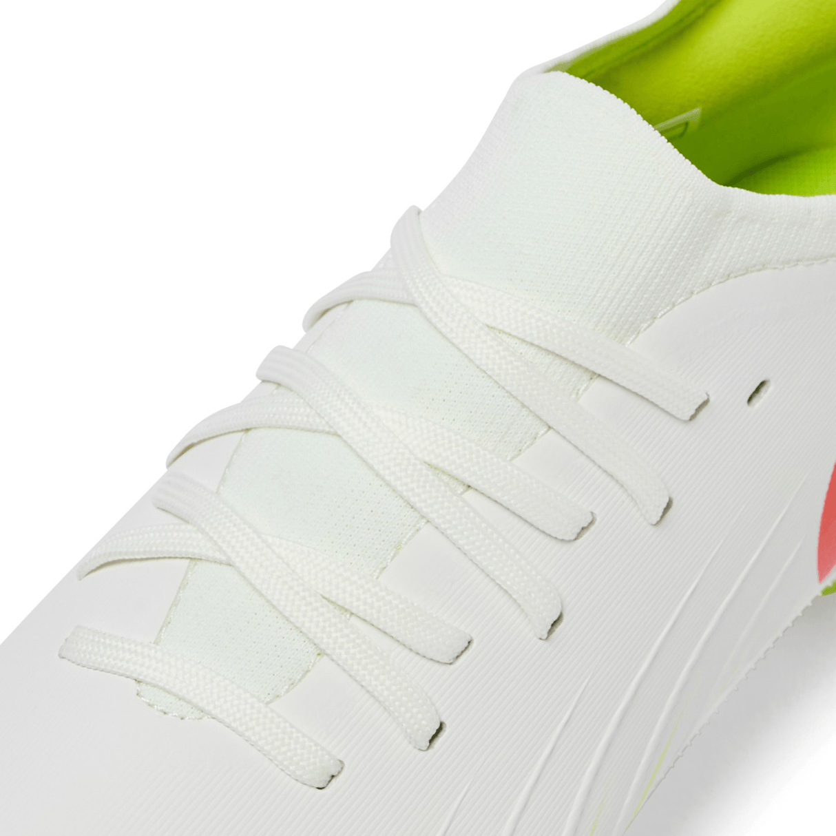 Close-up of the Canterbury Speed Falcon Pro SG in Snow White/Tangerine Tango, showcasing white laces and a light green interior lining.